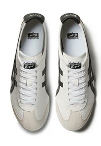 Hvide lædersneakers med sorte striber, rund tå og teksturerede detaljer. Med hvide snørebånd og en polstret sort hælflap.