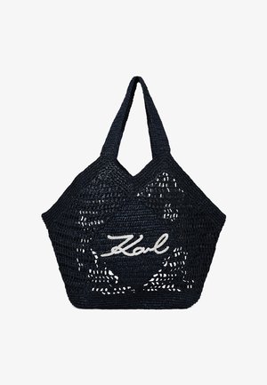 Sac fourre-tout tissé bleu marine avec une forme structurée, présentant un design ajouré et le logo "Karl" brodé en blanc sur le devant. Deux poignées tressées.