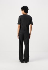 Jack & Jones JPSTBILL JJDAYTONA WIDE - Trousers - black