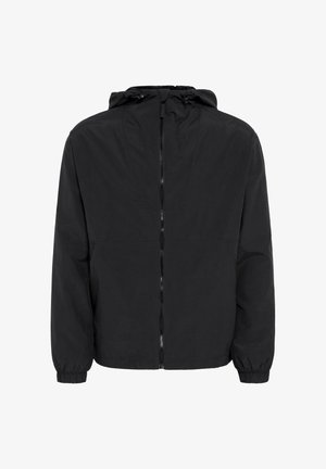 Melnā jakā ar rāvējslēdzēju un kapuci, elastīgām piedurknēm un gludu, vieglu audumu. Vienkāršs dizains, piemērots ikdienas valkāšanai.