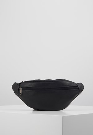 Bolso de cintura de cuero negro con dos compartimentos con cremallera, exhibido sobre un pedestal blanco frente a un fondo gris.