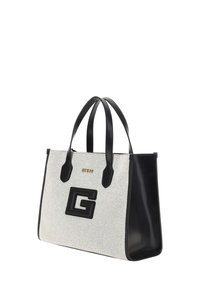 Borsa a tracolla in tela beige con dettagli in pelle sintetica nera, dotata di doppie maniglie e un grande logo nero 'G' sulla parte anteriore. Scritta dorata.