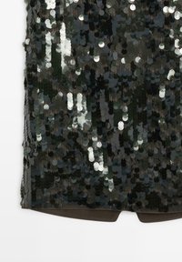 Black fabric covered with densely sewn reflective dark green and silver circular sequins, showing texture and varying light reflections.
