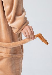 Fleece animal-themed robe in light beige with a soft texture. Features a hand holding a plush tail extending from the robe.
