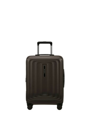 Dark brown hard-shell suitcase with telescopic handle and four spinner wheels, standing upright on a white background.