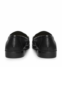 Black leather loafers with a smooth texture, rounded toe, and low heel. Features stitching along the sides and a slip-on design.
