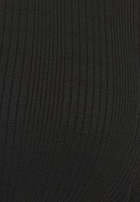 Black ribbed fabric close-up, featuring vertical lines and a lightweight texture. The uniform design has a slight sheen and no visible patterns.