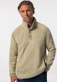 Lys beige fleece-pullover med høj krave, trykknapper og en tekstureret overflade. Har et subtilt mønster og en afslappet pasform.