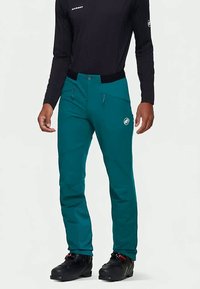 Türkisfarbene Outdoor-Hose aus Stretchstoff, mit Seitentaschen, Knopfverschluss und Logodetail am Oberschenkel.