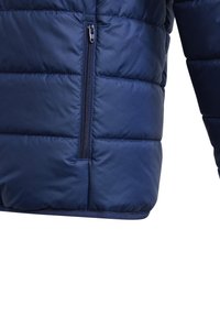 Navy blue puffer jacket with quilted design, featuring a side zippered pocket and smooth texture. Hem is finished with a plain band.