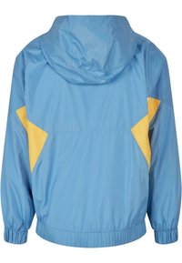 Giacca pullover di un azzurro chiaro con pannelli gialli a contrasto. Caratterizzata da un cappuccio, polsini elasticizzati e una vestibilità comoda. Materiale liscio e leggero.