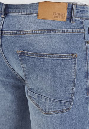 Light blue denim jeans featuring a back pocket, leather label at the waistband, and contrasting stitching details.