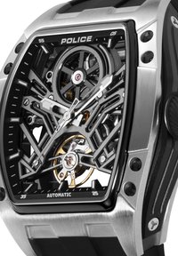 Policijska avtomatska ura z ohišjem iz nerjavečega jekla, črnim okostnatim številčnico, zlatimi poudarki in gumijastim trakom. Opazni so izredno natančni detajli dizajna.