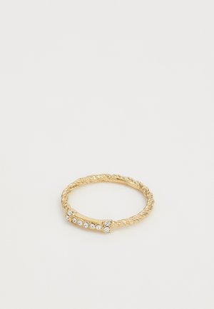 Gold twisted metal ring featuring a smooth band with a row of five clear gemstones set in a polished accent.