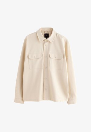 Beige langärmelige Hemdjacke mit Kragen, Knopfleiste vorne und zwei Brusttaschen mit Klappen und Knöpfen.