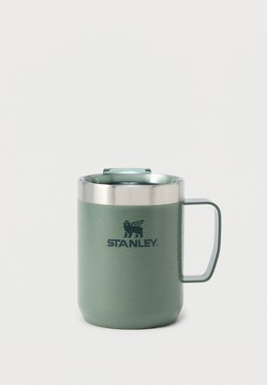Zelený nerezový izolovaný hrnek Stanley s rukojetí a víčkem na bílém pozadí.