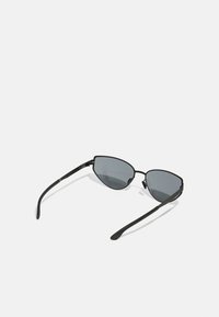 Black cat-eye sunglasses with dark lenses. Slim metal frame features curved temples and subtle hinges. Smooth matte finish.