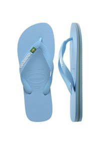 Vaaleansiniset flip-flopit, joissa on teksturoitu kumipohja ja erottuva vihreä-keltainen-musta raita reunassa. Varressa Havaianas-logo.