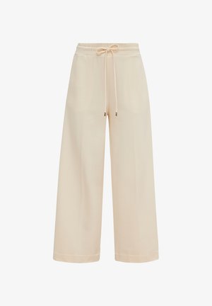 Pantalons beige à jambes larges en tissu doux, dotés d'une taille élastique avec un cordon de serrage et des embouts en métal aux extrémités. Texture lisse.