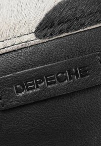 Black leather wallet featuring a cowhide texture with white and black patches. A debossed "DEPECHE" logo is visible on the surface.