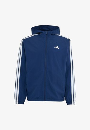 Granatowa bluza z kapturem na zamek błyskawiczny, z białymi paskami na rękawach i małym białym logo Adidas na piersi.