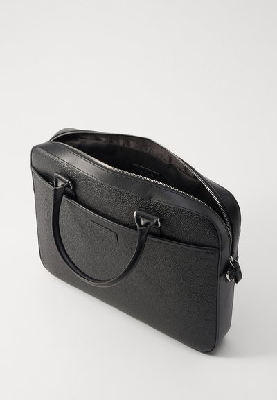 Black leather briefcase with textured surface, two handles, zip closure, and one outer pocket. Interior lined in dark fabric.