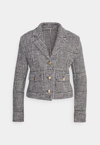 Svart och vit rutig kavaj med en strukturerad design, med guldknappar, slagkrage och långa ärmar. Texturerad tyg.
