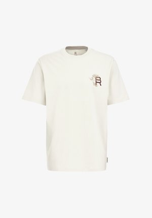 T-shirt en coton blanc à manches courtes, avec un petit motif graphique marron et beige sur la poitrine gauche. Col rond simple.