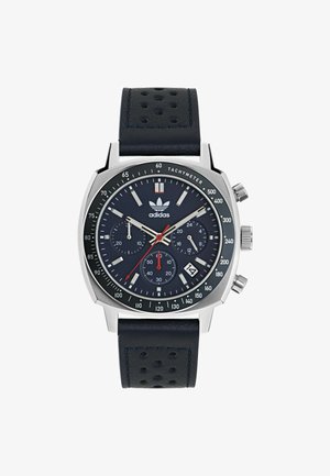 Silver stainless steel watch with a navy dial, featuring chronograph subdials, date display, and a perforated navy leather strap.