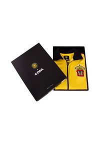 Geel ritsjack met zwarte kraag, voorzien van een crest ontwerp, verpakt in een zwarte doos met glanzende afwerking en logo-accenten.