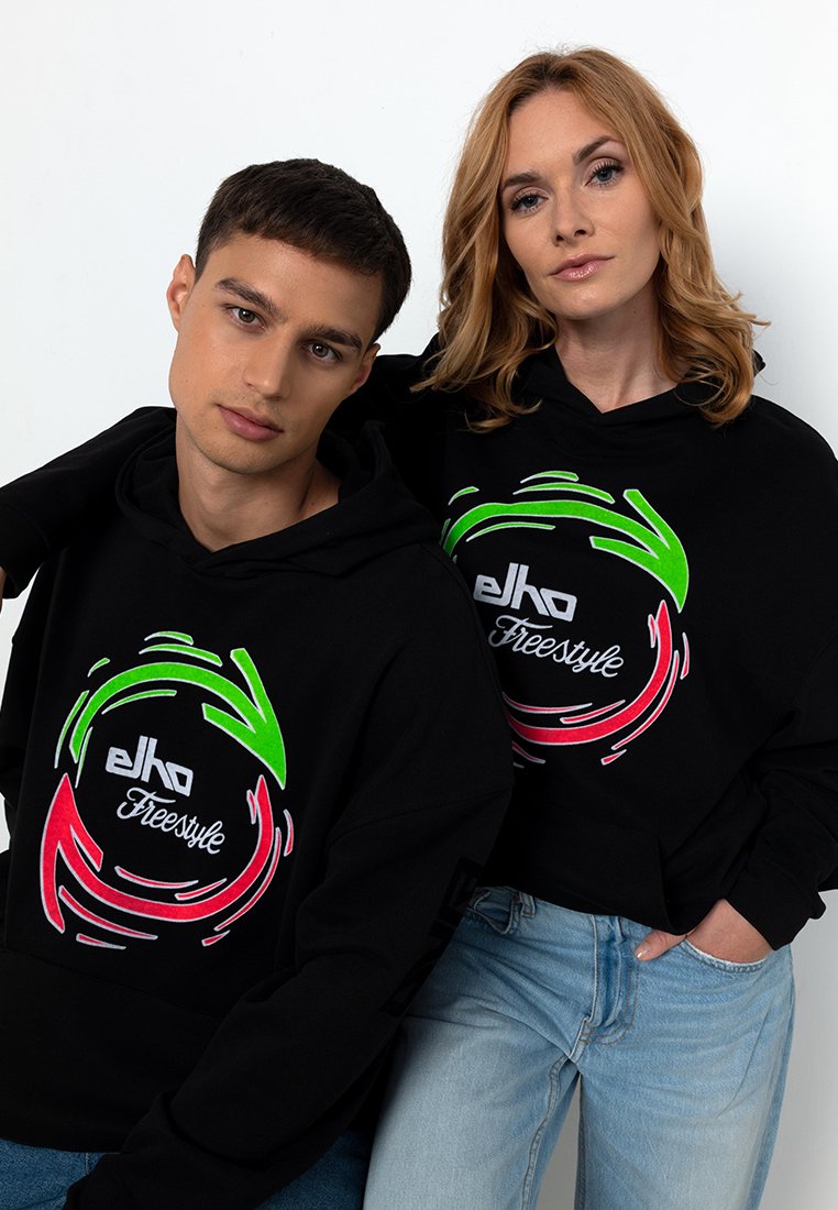 Schwarze Hoodies mit einem runden Grafikdesign in Rot und Grün. Das Material scheint weich zu sein; das Design umfasst den Text "elko Freestyle." Standardpassform.