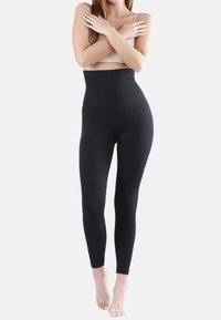 Leggings neri a vita alta con una texture a coste, caratterizzati da un design senza cuciture e una forma aderente, adatti per comfort e flessibilità.