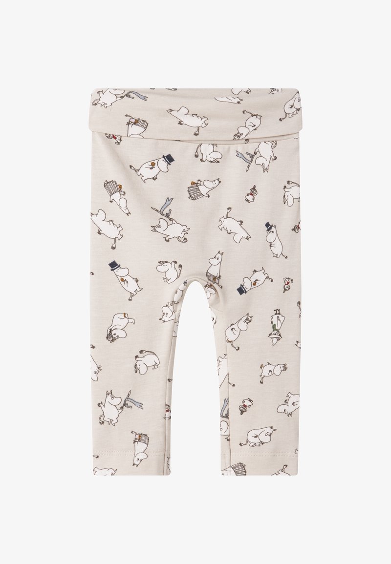 Beżowe legginsy z elastycznym paskiem w talii, ozdobione powtarzającym się wzorem postaci przypominających kreskówki oraz różnorodnymi dodatkami w ciemniejszych kolorach.