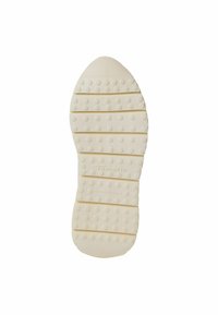 Vit texturerad gummischula med upphöjda cirkulära mönster, med horisontella spår och varum�ärket "Tamaris" präglat.