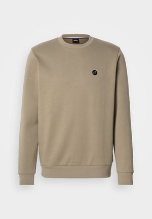 Beige sweatshirt made of cotton blend fabric. Features a round neckline and long sleeves with ribbed cuffs. Small black logo on chest.