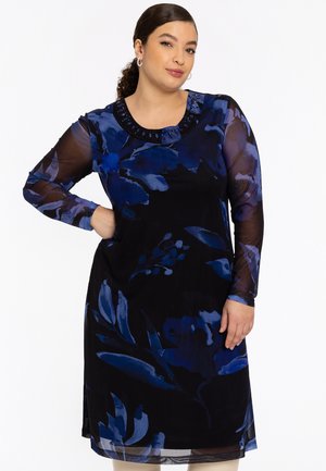 Robe à manches longues noire avec des motifs floraux bleus, dotée d'un col rond orné de perles décoratives. Tissu léger et fluide.