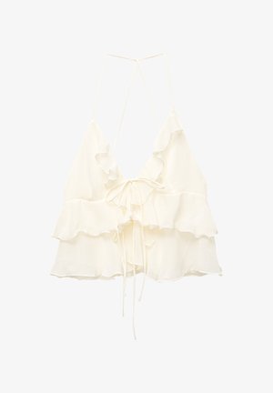 Top court blanc à volants avec un décolleté en V plongeant, des liens ajustables à l'avant et de fines bretelles, fabriqué en tissu léger.