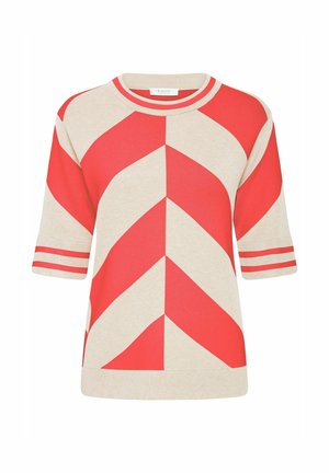 Cremefarvet og rød kortærmet sweater med et iøjnefaldende zigzag-mønster og kontrasterende stribede detaljer på manchetten og halsudskæringen.