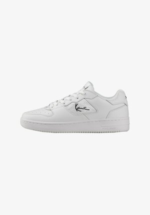 White athletic sneakers made of smooth leather with a perforated toe box, featuring a stylized black logo and a textured rubber sole.