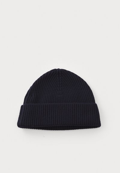 Navy ribbed knit beanie with a folded cuff, textured pattern, and a rounded top. Soft fabric with a snug fit.