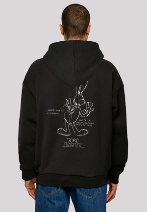 Black hoodie with a drawstring, featuring a white outline of Bugs Bunny on the back, highlighting design details and text annotations.