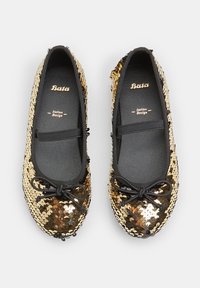 Black and gold sequined ballet flats with a round toe, elastic strap, and bow detail on the front. Smooth inner lining and flat sole.