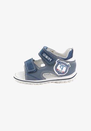 Sandalo azzurro e bianco per bambini piccoli con due cinturini in velcro regolabili e toppa con logo a forma di scudo sul lato.