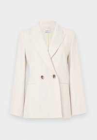 Beige dubbelgeknoopt colbert met goudkleurige knopen, met inkepingen in de revers en lange mouwen. Gemaakt van een gladde stof met een getailleerde pasvorm.