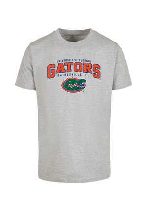 Heather šedé bavlněné tričko má nápis "University of Florida GATORS" v oranžové barvě, pod ním je grafika zeleného aligátora. Ležérní design.