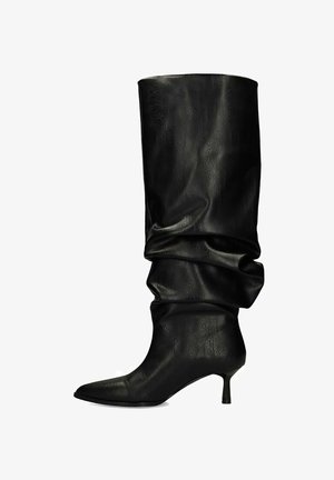 Black slouchy leather knee-high boot with pointed toe and thin kitten heel.