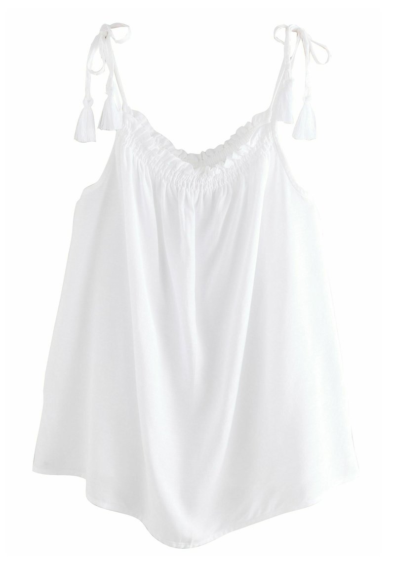 Haut sans manches blanc avec des bretelles réglables et des détails en franges. Présente un encolure élastique froncée et une coupe fluide et ample. Tissu doux.