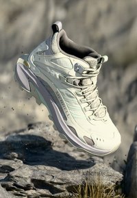 Light grey Merrell hiking shoe with a mesh upper, reinforced toe cap, and a rugged sole featuring deep treads. Gore-Tex branding visible.