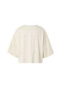 T-shirt oversize à manches courtes couleur blanc cassé, montré de dos avec des épaules tombantes et une coupe ample.