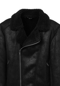 Giacca in shearling nera con colletto ampio e testurizzato, zip frontale asimmetrica e tasche laterali con zip.